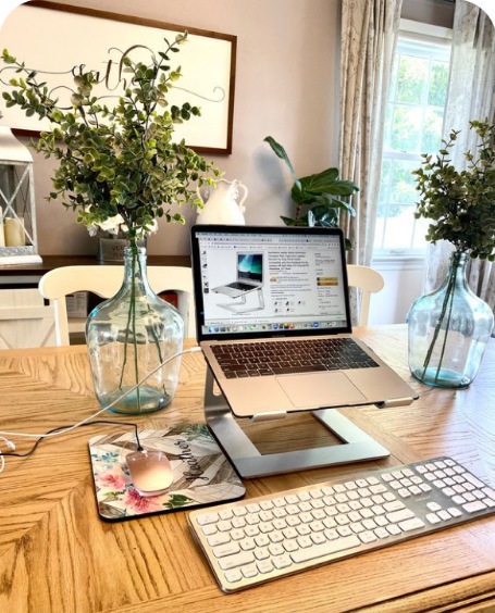 Sunlit creative desk with flowers